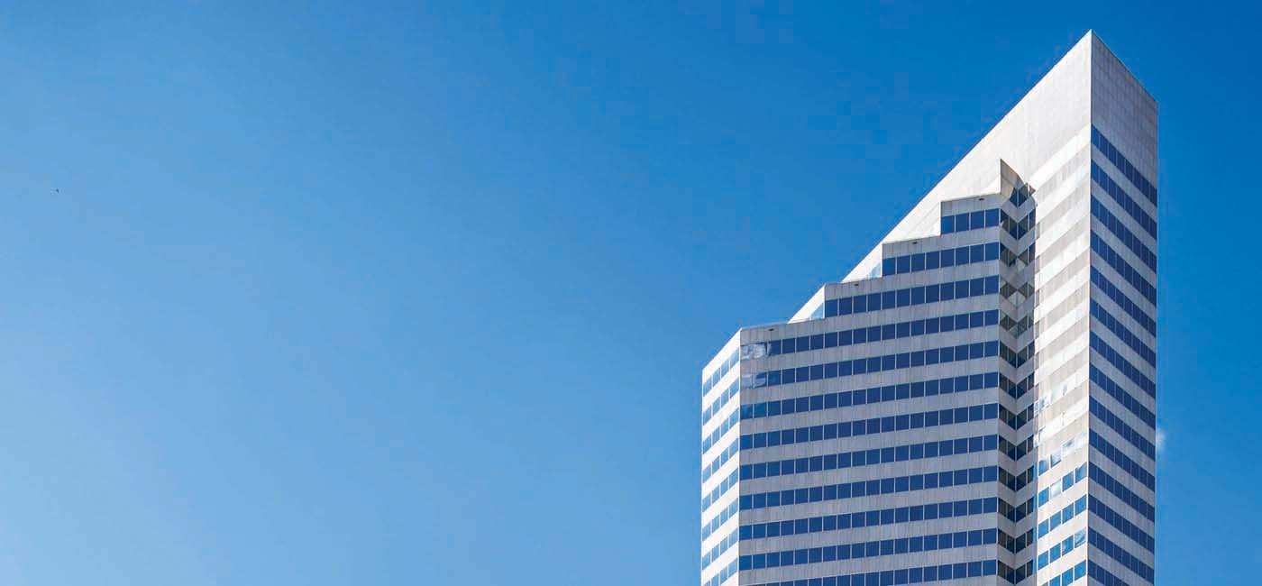 Image of the upper floors of Fulbright Tower with a blue sky in the background