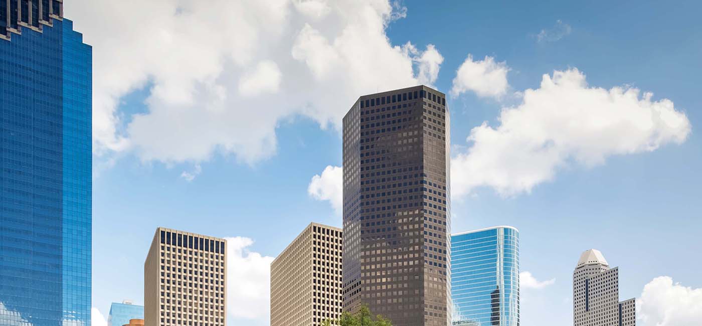 Image of Houston Skyline with Three Allen in the center. Skies are partially cloudy