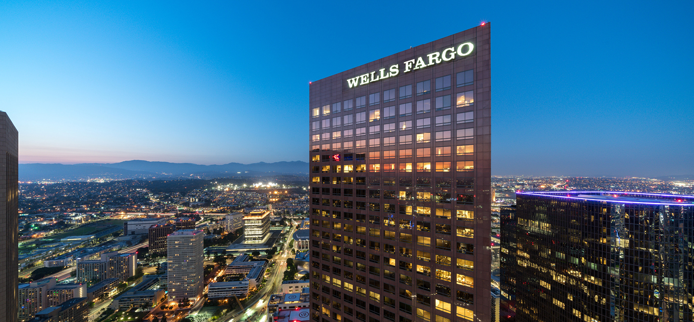 Image of the upper levels of Wells Fargo Center at dusk with the mountains and LA in the background