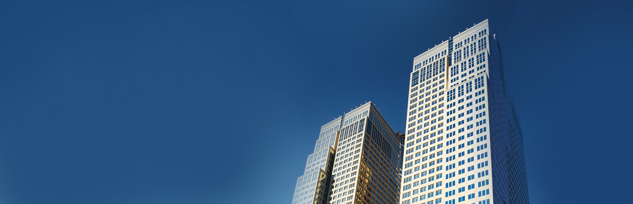 Image of the top of the east and west towers at Bankers hall with a clear blue sky