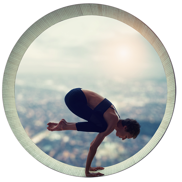 Woman with short hair in tights and top diong a yoga crow pose in a circular window