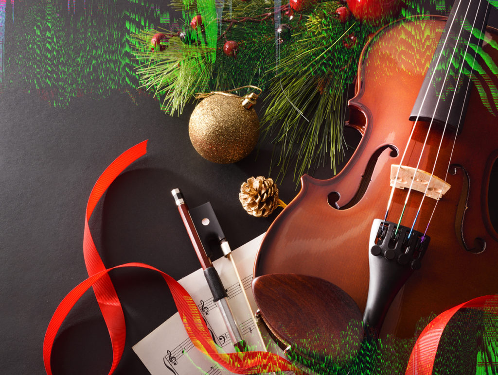 Violin nestled in holiday ribbons and greenery.