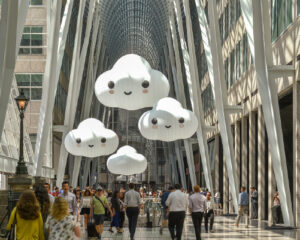 Inflated cartoonish happy clouds are strung throughout the upper levels of the allen lambert gallery.