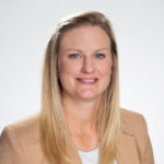 Portrait of Michelle Brown in a beige coloured blazer with a white shirt.