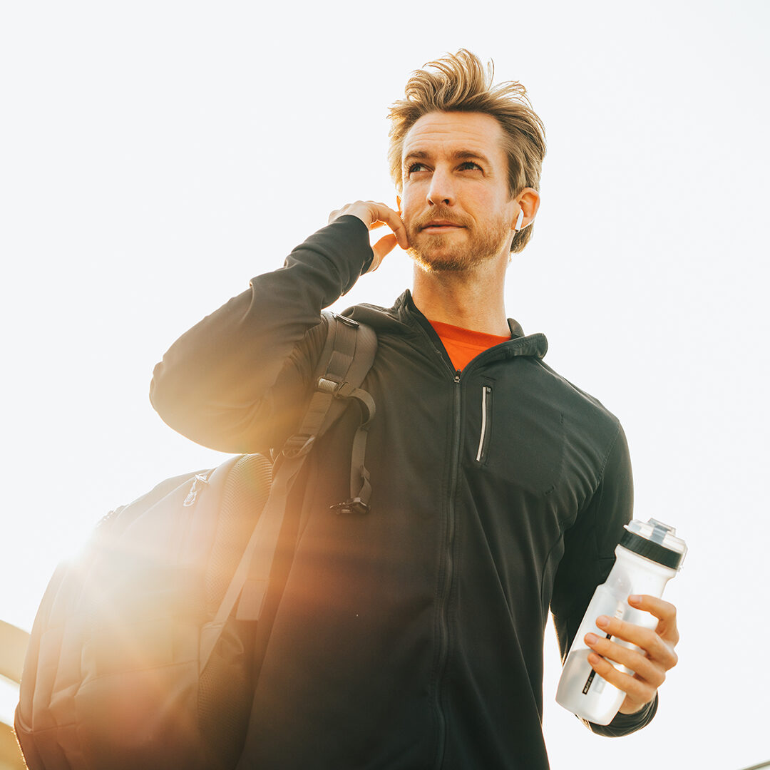 Gentleman in atheltic wear with a bag and bottle, ready for his next workout